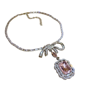 Elegant silver-tone necklace with a zircon bow pendant and large pink rectangular gemstone