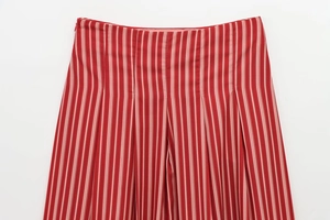 Detailed macro of high-waisted red and white striped midi skirt with pleated texture