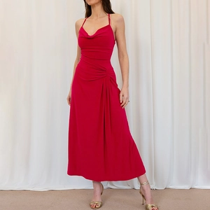 Close-up of red cowl neck sleeveless evening dress with pleated waist detailing
