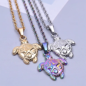 Minimalist sea turtle pendants in gold, rainbow and silver tones with shell carvings