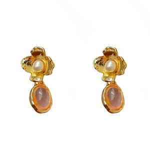 Vintage gold floral earrings with white pearls and pink oval gemstone pendants on white backdrop