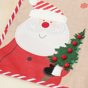 Detail of Christmas snowman embroidery on textured linen placemat for festive table decor