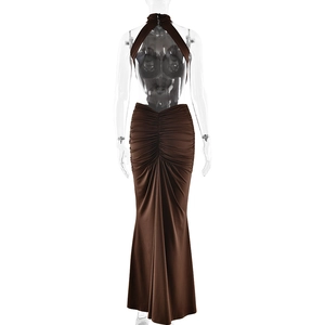 Detail of elegant halter neck long dress with backless design and waist ruching details