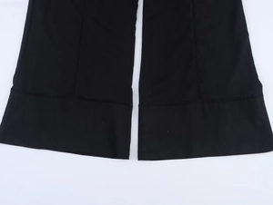 Detail shot of black linen-texture wide leg pants showing hem stitching and fabric quality