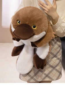 Detail of soft brown platypus plush toy showing fluffy texture and duckbill in model hands