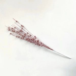 Close-up of glittery rose gold Christmas berry stems for tree and holiday decoration