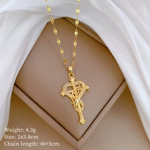 Detailed close-up of a gold heart pendant with MOM engraving and sparkling zircon accents