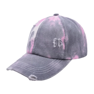 Detail of tie-dye ponytail baseball cap with vintage distressed torn effects