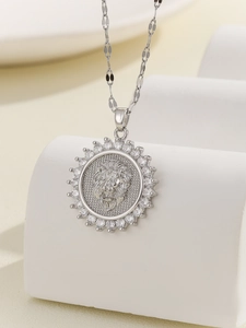 Macro shot of silver lion head pendant with micro-paved zircons on a white display stand