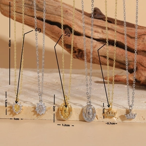 Virgin Mary zircon choker necklace set with gold and silver pendants on sandstone