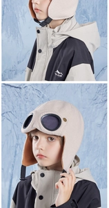 Close-up of beige corduroy kids pilot hat with goggles and warm faux lamb wool lining