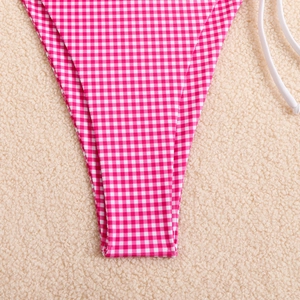 Detail of pink and white gingham bikini bottom with secure side tie and smooth fabric