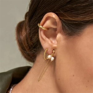 Detailed view of s925 silver tassel chain earrings with white pearls on a model
