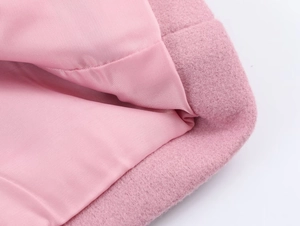 Detail view of pink wool-like blazer fabric texture and matching smooth inner lining