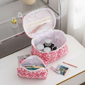Detailed set of two floral travel toiletry bags with mesh pockets and zipper closure