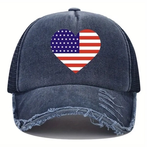 Detail of distressed brim and American flag heart print on washed denim baseball cap