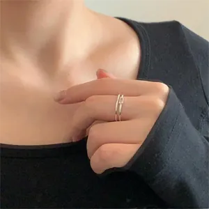Close-up of a 925 silver minimalist double-layer ring with square zircon on model's finger
