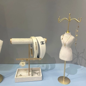 Minimalist jewelry display stand featuring hairbands, necklaces and elegant accessories