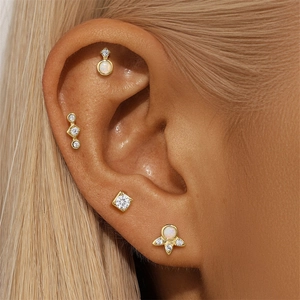 Detailed close-up of S925 silver gold-plated stud earrings with opal and zircon insets