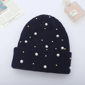 Deep blue ribbed knit beanie featuring elegant white pearls and metallic bead accents