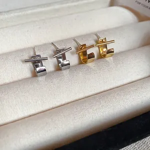 Minimalist J-shaped geometric stud earrings in gold and silver finish with metal bar