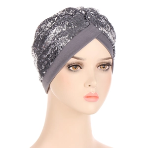 Close-up of sparkling silver sequins and crisscross design on a dark grey turban hat