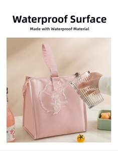 Waterproof detail of a pink insulated lunch bag with portable top handle and sleek design