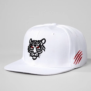 Macro detail of the tiger head embroidery and red claw marks on a white snapback cap