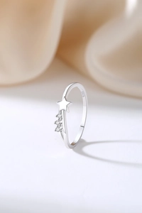 Detail of 925 sterling silver ring featuring a polished star and sparkling zircon stones