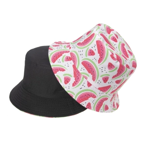 Detail of reversible bucket hat showing plain black side and summer watermelon print