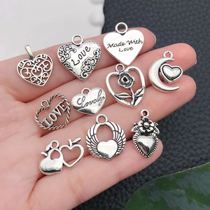 Set of 10 vintage silver heart charms with intricate hollow patterns and love engravings