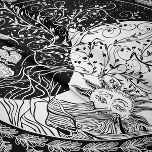 Detail of high-contrast sun and moon tapestry with mystical occult fabric patterns