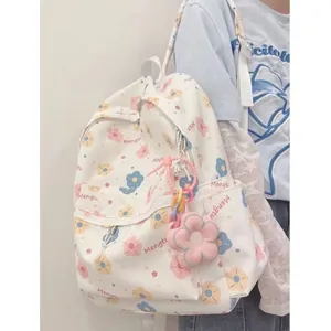 Detail of white floral school backpack with cute flower pendant and Mengtu print
