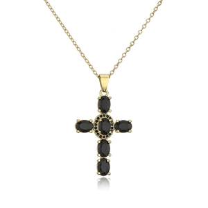 Macro view of gold-plated cross pendant featuring oval black stones and fine pavé setting