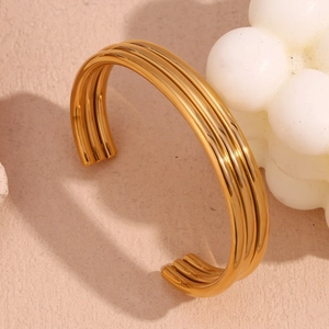 Close-up of triple-layered wavy 18K gold plated stainless steel open cuff bracelet
