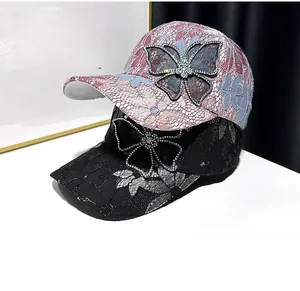 Close-up of elegant lace baseball caps featuring sparkling rhinestone butterfly details