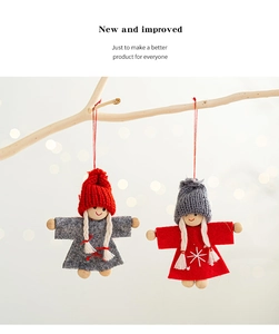 Detail of handmade Nordic Christmas dolls with felt skirts and knitted hats on wood branches