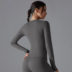 Slim fit long sleeve yoga top in dark grey showing smooth elastic fabric and seam detail