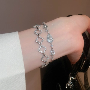 Detail showing clover and gourd charm bracelets with pearls and sparkling zircons