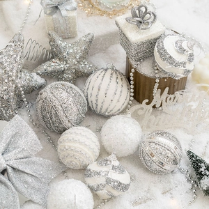 Silver and white Christmas ball ornaments set with stars and Merry Christmas sign