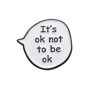 Minimalist speech bubble enamel brooch featuring It's ok not to be ok motivational slogan
