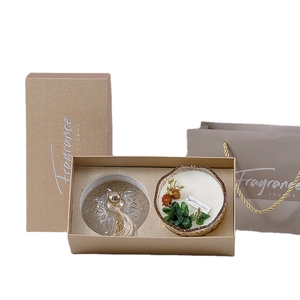 Amber glass scented candle with dried flowers in a premium gold gift box and bag