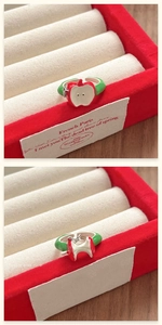 Macro detail of asymmetric red bitten apple ring on a velvet jewelry box display