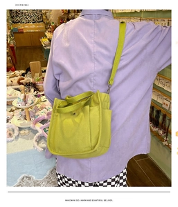 Fluorescent green canvas messenger bag showing large capacity and crossbody strap