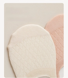 Detail of reinforced flat toe seams on breathable mesh socks in beige and light pink
