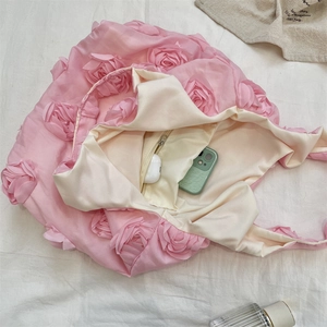 Interior view of pink floral tote bag showing large capacity for phone and accessories