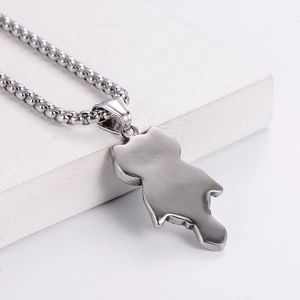Stainless steel owl pendant necklace with silver bead chain on white minimalist background