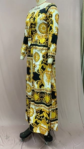 Detailed view of the baroque scroll pattern and bow tie collar on the vintage maxi dress