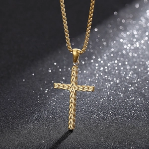 Detailed view of golden cross pendant with woven texture on a sleek box chain design