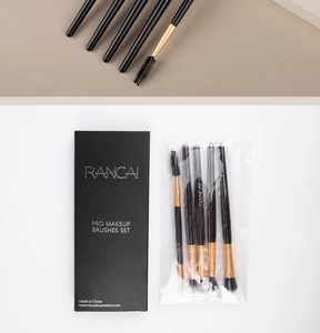 Detail showing dual-ended eye makeup brushes with gold ferrule and branded black box
